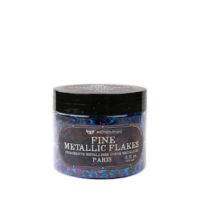 May include: A jar of fine metallic flakes with a black lid. The label reads "FINE METALLIC FLAKES" and "PARIS". The flakes are a mix of blue, purple, and silver. The jar contains 5 fl oz of flakes.