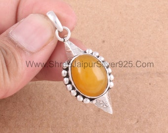 May include: Silver pendant with an oval, amber-colored stone. The stone is set in a decorative silver frame with a beaded border and a stylized leaf design. The pendant has a loop for a chain. The website address www.ShreeJaipurSilver925.com is visible.
