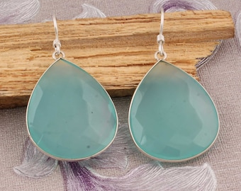 May include: A pair of silver teardrop earrings with light blue chalcedony stones.