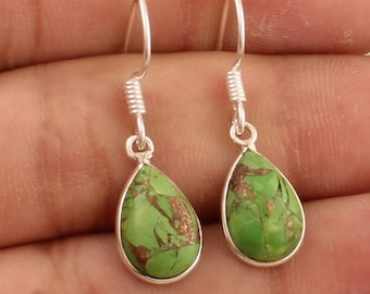 May include: A pair of silver dangle earrings with green gemstone drops. The gemstones have a marbled pattern with gold flecks.