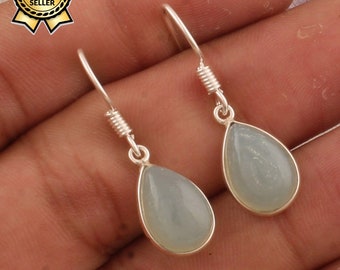 May include: A pair of silver dangle earrings with light blue teardrop-shaped stones.