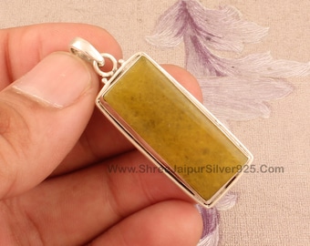 May include: A silver pendant with a rectangular yellow gemstone. The pendant has a bail for attaching to a chain. www.ShreJaiPurSilver925.com