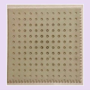 May include: A square, light beige board featuring a uniform grid of small, circular, dark-edged holes. The right and bottom edges of the board are finished with a series of small, evenly spaced notches along the entire length of the sides.