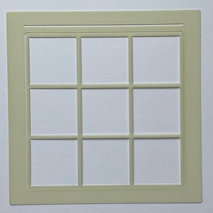 May include: A white plastic stencil with a grid pattern of nine squares. The stencil is designed for crafting and DIY projects.