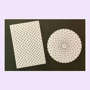 May include: A white rectangular pegboard with a grid of evenly spaced holes and a white circular pegboard featuring a radial pattern of holes arranged in concentric circles, both designed for crafting or organising small items.
