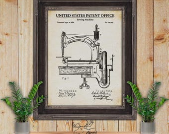 May include: A black and white vintage patent drawing of a sewing machine. The patent drawing is framed in a dark wood frame. The patent number is 345,395 and the patent date is September 21, 1886. The title of the patent is "United States Patent Office Sewing Machine".