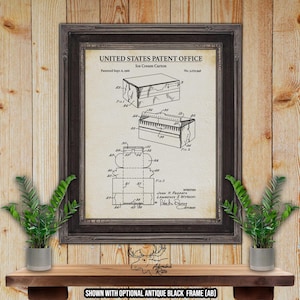 May include: A vintage United States Patent Office print shows a design for an ice cream carton.  The sepia-toned patent drawing features three diagrams illustrating the carton's construction.  The patent number, date, and inventor names are clearly visible. The print is framed in a dark brown frame against a wood background.  The text includes 'United States Patent Office', 'Ice Cream Carton', 'Patented Sept. 6, 1966', and 'No. 1,270,906'.