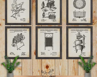 May include: Six vintage black and white patent drawings of laundry equipment, including a wringer, a washing machine, and a laundry basket. Each drawing is framed in a rustic black frame and displayed on a wood wall.