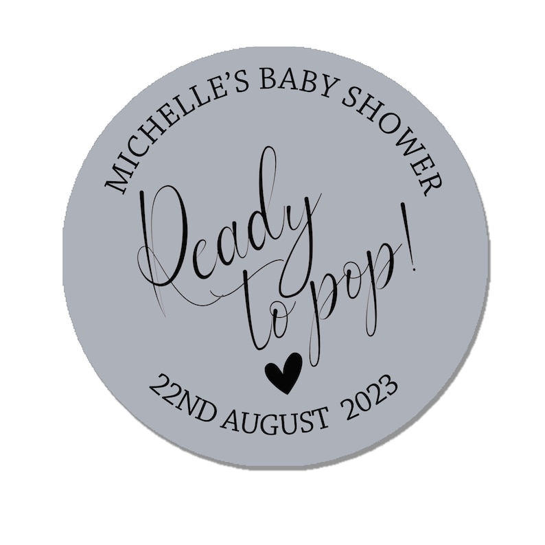 May include: A gray circle sticker with the text "Michelle's Baby Shower" and "Ready to pop!" in black cursive font. The date "22nd August 2023" is also printed in black.