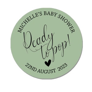 May include: A green circle sticker with the text "Michelle's Baby Shower" and "Ready to pop!" in black script. The date "22nd August 2023" is also printed in black.