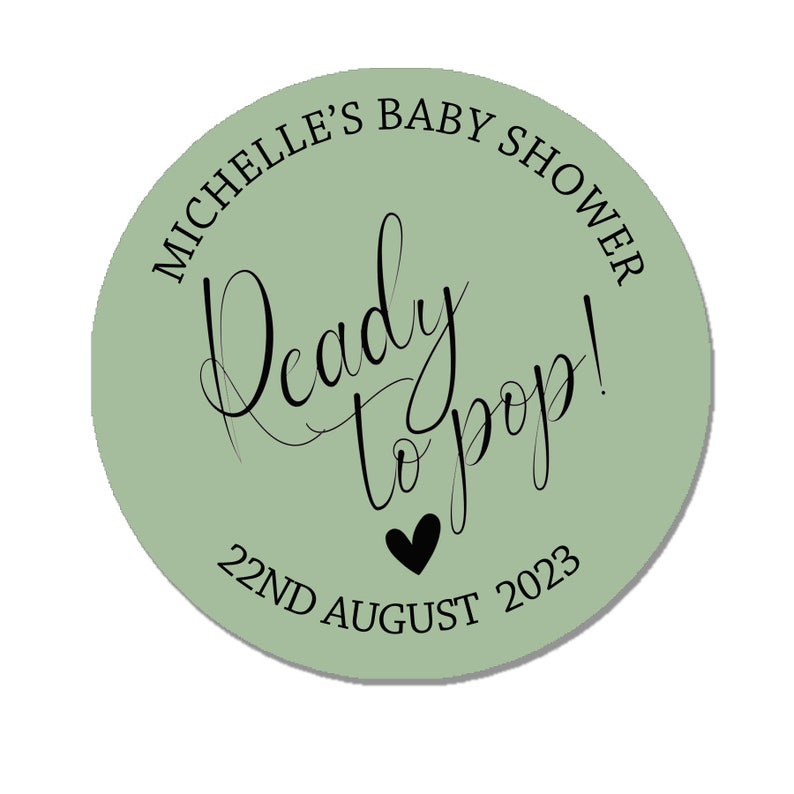 May include: A green circle sticker with the text "Michelle's Baby Shower" and "Ready to pop!" in black script. The date "22nd August 2023" is also printed in black.