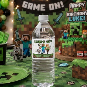 May include: A clear plastic water bottle with a white cap and a label reading "Luke's 10th Birthday", featuring Minecraft characters. The bottle is part of a Minecraft-themed party, with a cake, decorations, and tableware.