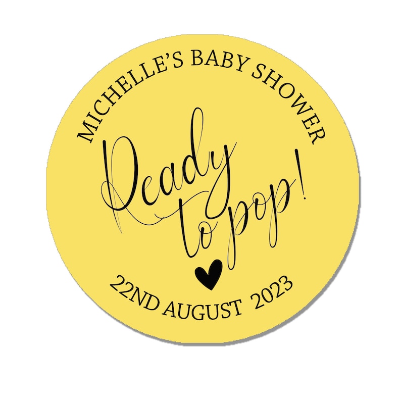 May include: Yellow circle sticker with black text that reads "Michelle's Baby Shower Ready to Pop! 22nd August 2023".