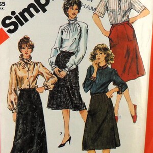 May include: Simplicity sewing pattern featuring illustrations of four different women's outfits. The outfits include blouses, skirts, and a collared shirt. The pattern includes the text "Fuss-Free Fit".