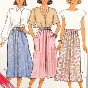 May include: A sewing pattern for three different skirts. The skirts are all knee-length and have a gathered waist. The first skirt is a light blue with a floral pattern, the second is a pink with a solid color, and the third is a white with a floral pattern. The pattern includes instructions for making the skirts.