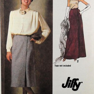 May include: A sewing pattern envelope featuring a cream long-sleeve button-down shirt and a grey knee-length wrap skirt, alongside an illustration of a long maroon skirt. The text includes the brand name Jiffy and the phrase Tops not included.