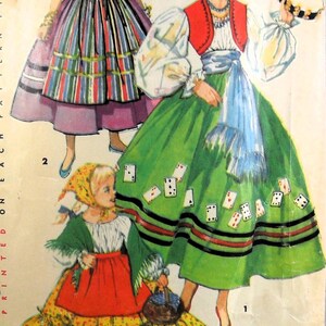 May include: A vintage sewing pattern illustration featuring three figures in folk-inspired outfits. One figure wears a green skirt with playing card motifs, a red vest, and a white blouse. Another wears a striped skirt and yellow vest. A child wears a floral skirt.