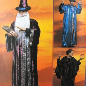 May include: A collection of three costumes featuring a purple velvet robe with silver trim and a matching pointed hat, a metallic blue robe with a pointed hat, and a black textured robe with a dark shawl and a round glowing orb accessory.