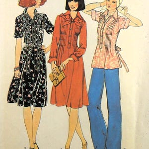 May include: Illustration of three vintage fashion outfits. The first is a black floral print dress with a belt. The second is a long-sleeved, orange dress. The third is a pink floral top with blue flared pants. All outfits are from the 1970s.
