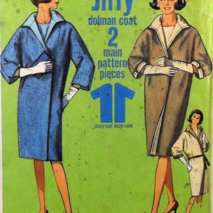 May include: A vintage sewing pattern envelope for a Jiffy dolman coat featuring two main pattern pieces. The bright green cover displays illustrations of three coats in blue, brown, and white, each with a wide collar and three-quarter length sleeves.