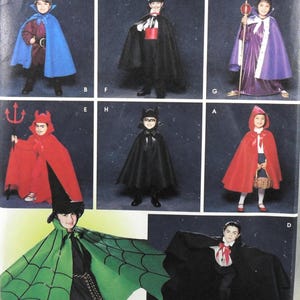 May include: A sewing pattern sheet displaying eight costume variations including capes, robes, and accessories. The designs feature a blue cape, a black tuxedo-style cape, a purple royal robe, a red devil cape, a black bat cape, a red hooded cape, a green spiderweb cape, and a black vampire cape.
