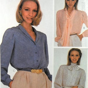 May include: A sewing pattern for three different blouses. The first blouse is a white blouse with a bow tie. The second blouse is a light pink blouse with a bow tie. The third blouse is a light blue blouse with a collar.