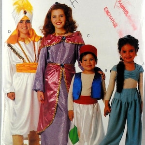 May include: A sewing pattern envelope featuring four costumes: a white and gold outfit with a turban, a purple and pink gown with gold trim, a beige shirt with a blue vest and white pants, and a light blue two-piece outfit with a matching headband.