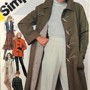 May include: Simplicity sewing pattern featuring a woman wearing a brown toggle coat with a cream-colored lining. The pattern includes illustrations of other coat and jacket styles. The text "Simplicity" is in large, bold letters.
