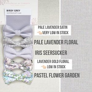 May include: An assortment of bow ties in various patterns and colors, including pale lavender satin, floral, and striped designs. The image also displays fabric swatches and text that reads "PinkPeony by Christy."