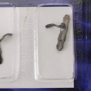 May include: Two antique-style door handles in a plastic packaging. The handles are made of metal and have a dark brown finish. The packaging is blue and white and has the text "Ship from Canada" printed on it.