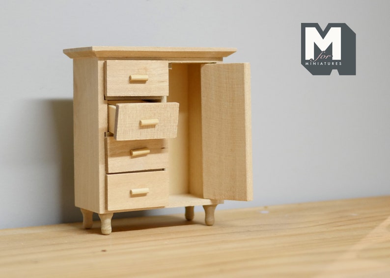 May include: A wooden cabinet with four drawers and a door. The cabinet is unfinished and has a natural wood color. The door is open and the drawers are partially open. The cabinet is sitting on a wooden surface.