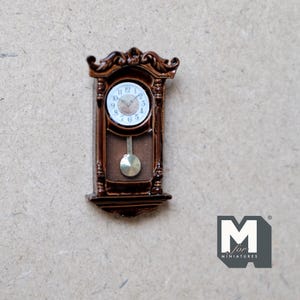 May include: A miniature wooden grandfather clock with a brown finish and a white face. The clock has a pendulum and Roman numeral markings.