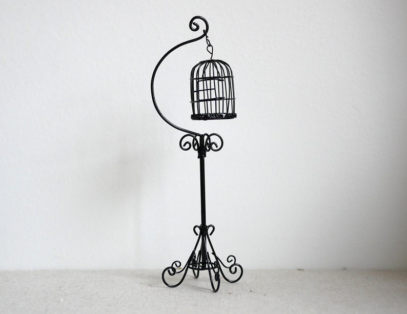 white bird cage with stand
