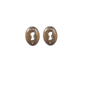 May include: A pair of gold-toned keyhole earrings. Each earring is shaped like an oval with a keyhole cutout in the centre.