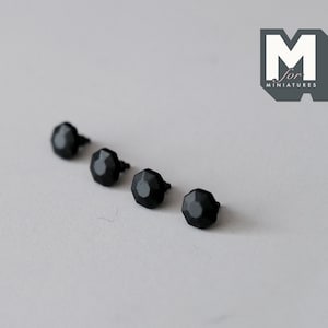 May include: Four black and gray metal hexagonal-shaped knobs with a small screw on the bottom.