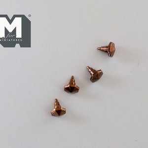 May include: Four copper-coloured, hexagonal-shaped, miniature furniture knobs with a threaded post on the bottom.