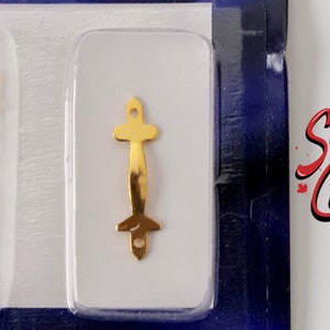 May include: Two gold-colored metal drawer pulls, one curved and one straight, are displayed on a white background. The pulls have two holes for attaching to a drawer.