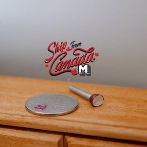 May include: A miniature silver coin with a red maple leaf design and a small metal rod with a red end. The text "Ship From Canada" is displayed in red script with a maple leaf accent.