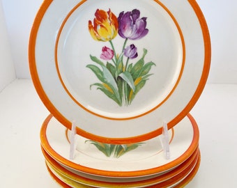 May include: Set of six white ceramic dessert plates with an orange rim and a floral design featuring a bouquet of tulips in shades of yellow, orange, purple, and pink.