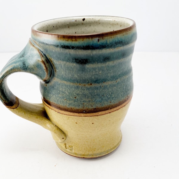 Vintage handmade, wheel thrown pottery mug in teal and tan