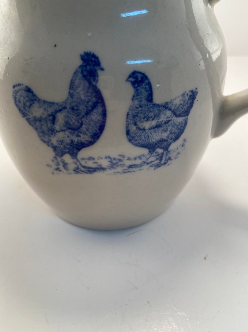 Vintage rustic farmhouse transferware pottery pitcher with a blue chicken and rooster