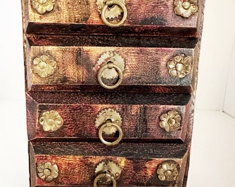 vintage four drawer wood and brass Chinese jewelry chest with filigree floral details and ring pulls