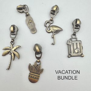 May include: Five antique brass-toned metal zipper pulls featuring vacation-themed charms: a flip-flop, a flamingo, a suitcase with the text Travel, a palm tree, and a potted plant. The text VACATION BUNDLE is printed in the lower right corner.