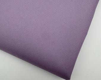 May include: A close-up of a folded piece of fabric in a muted lavender colour. The fabric has a tightly woven texture, with a slight sheen. The fabric is folded at an angle, showing the texture and colour variations.