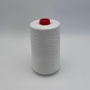 May include: A large spool of white thread with a red top. The thread is tightly wound around the spool, creating a cylindrical shape. The image is taken against a plain white background.