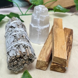 May include: A set of three smudging tools including a bundle of white sage, a selenite tower, and three palo santo sticks.