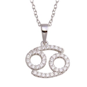 May include: Silver necklace with a pendant shaped like the Cancer zodiac sign. The pendant is encrusted with small, clear cubic zirconia stones.