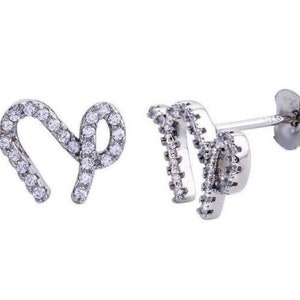 May include: Silver earrings with a sparkling cubic zirconia design in the shape of the astrological sign Virgo.