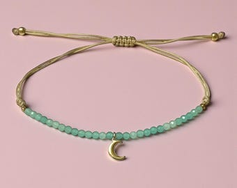 May include: A white ceramic mug with a black handle and the text "But First, Coffee" in a black, handwritten-style font. The mug is on a white surface.