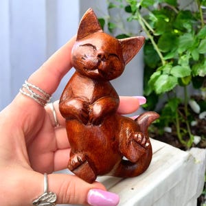 Teak Wood Sleepy Cat Figurine, Hand-Carved Relaxed Cat Statue, Peaceful Animal Totem for Shelf Decor, Calming Gift for Cat Lovers 4.9 (148.4k)